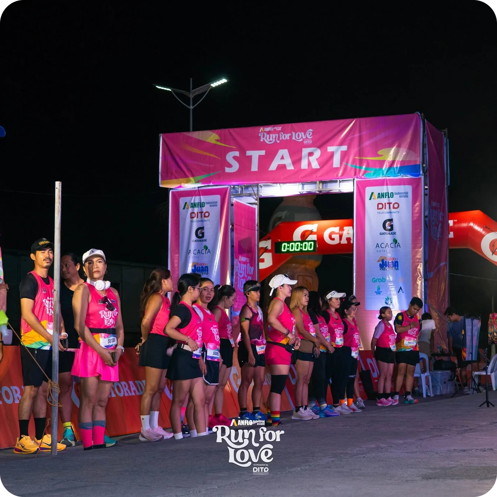 Run for Love — runners at the branded start arch before gun time